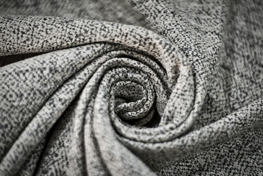 Detailed close-up of a gray fabric spiral showcasing intricate textures and patterns.