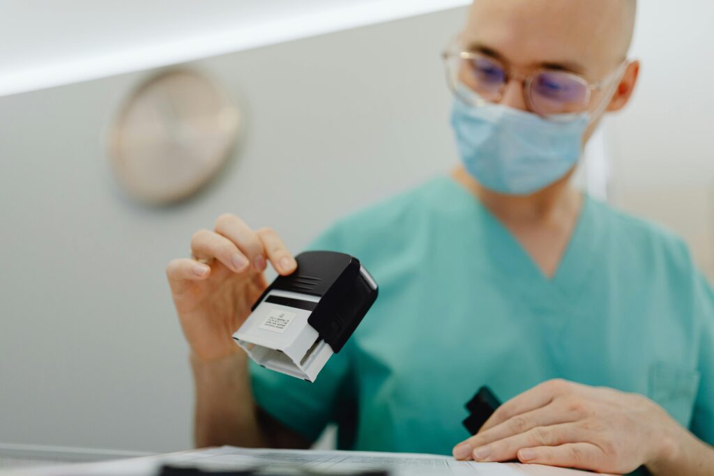 Healthcare worker stamping documents in a clinic setting, ensuring efficient workflow.